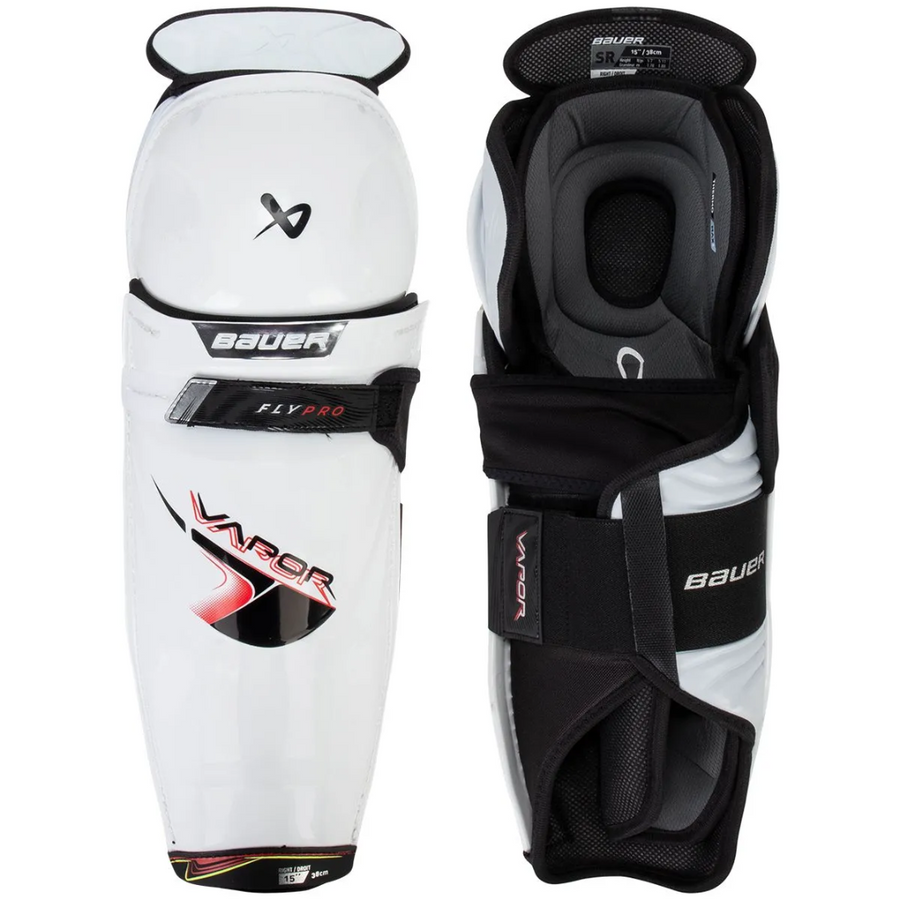 Pair of Bauer hockey shin guards on a white background
